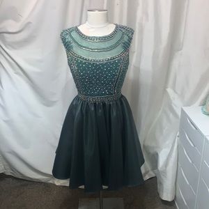 This is an emerald green prom dress with a beaded top and a satin skirt.